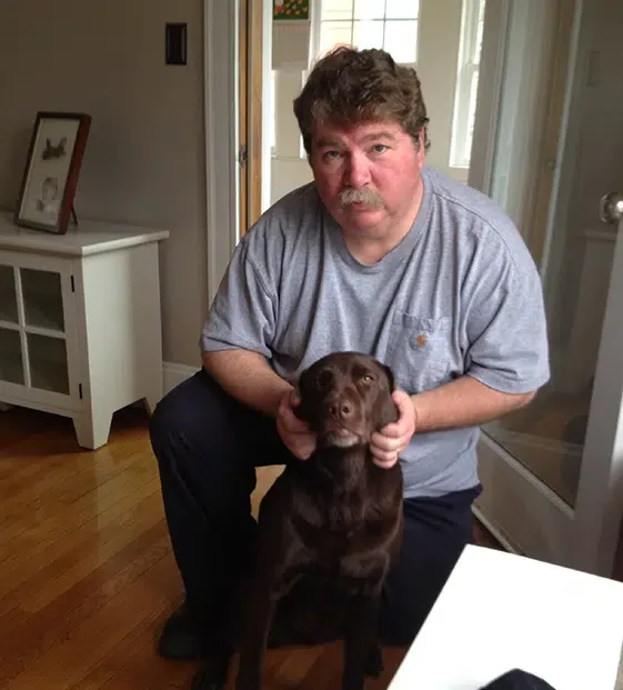 Friendly Castle Electric electrician with customer's dog during a Newton MA residential service call
