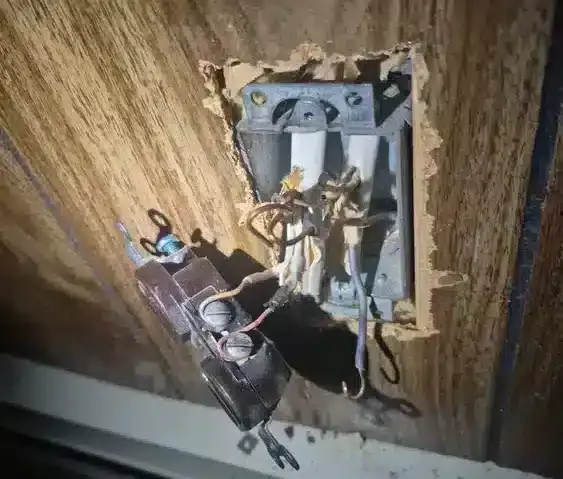 open outlet with exposed wiring
