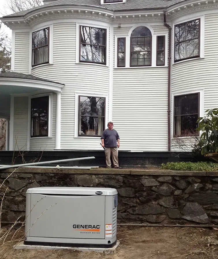 Generac Guardian Series standby generator installed outside historic Victorian home by Castle Electric electrician