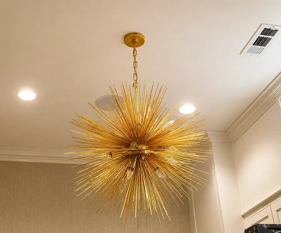 Gold starburst sputnik chandelier and recessed lighting installed by Castle Electric in Newton MA home