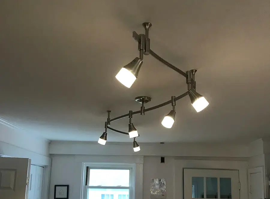 Brushed nickel flexible track lighting fixture installed in a Newton MA living room by Castle Electric