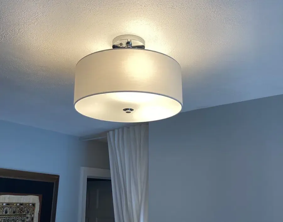 Flush-mount drum ceiling light fixture installation in an Eastern Massachusetts bedroom by Castle Electric