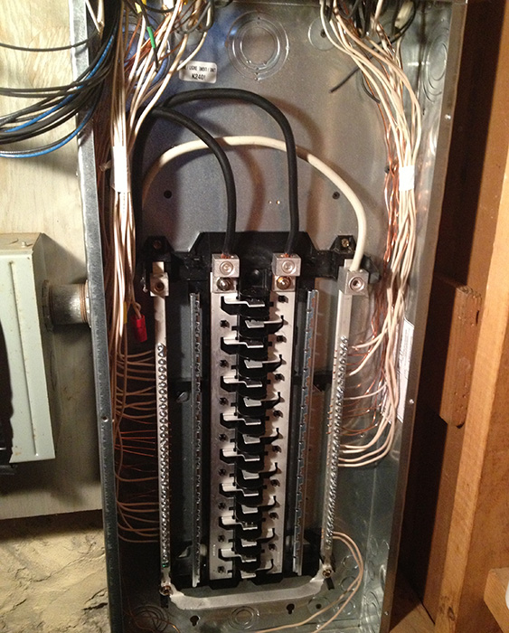 Residential electrical panel upgrade in Newton MA showing circuit breakers and copper wiring