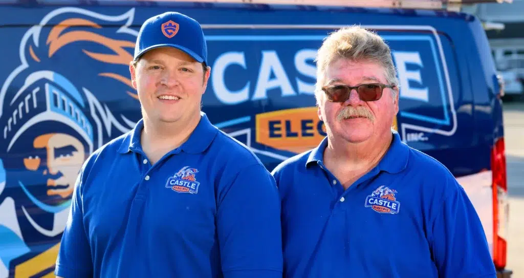 Jim Prescott Jr and Jim Prescott Sr, owners of Castle Electric, in front of a company van